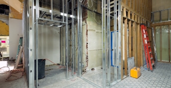 Interior photo of a commercial building undergoing commercial renovations showing metal and wooden studs